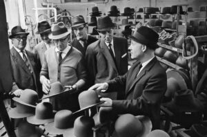 Men looking at hats who could well work in finance and may need the assistance of some freelance finance copywriters.